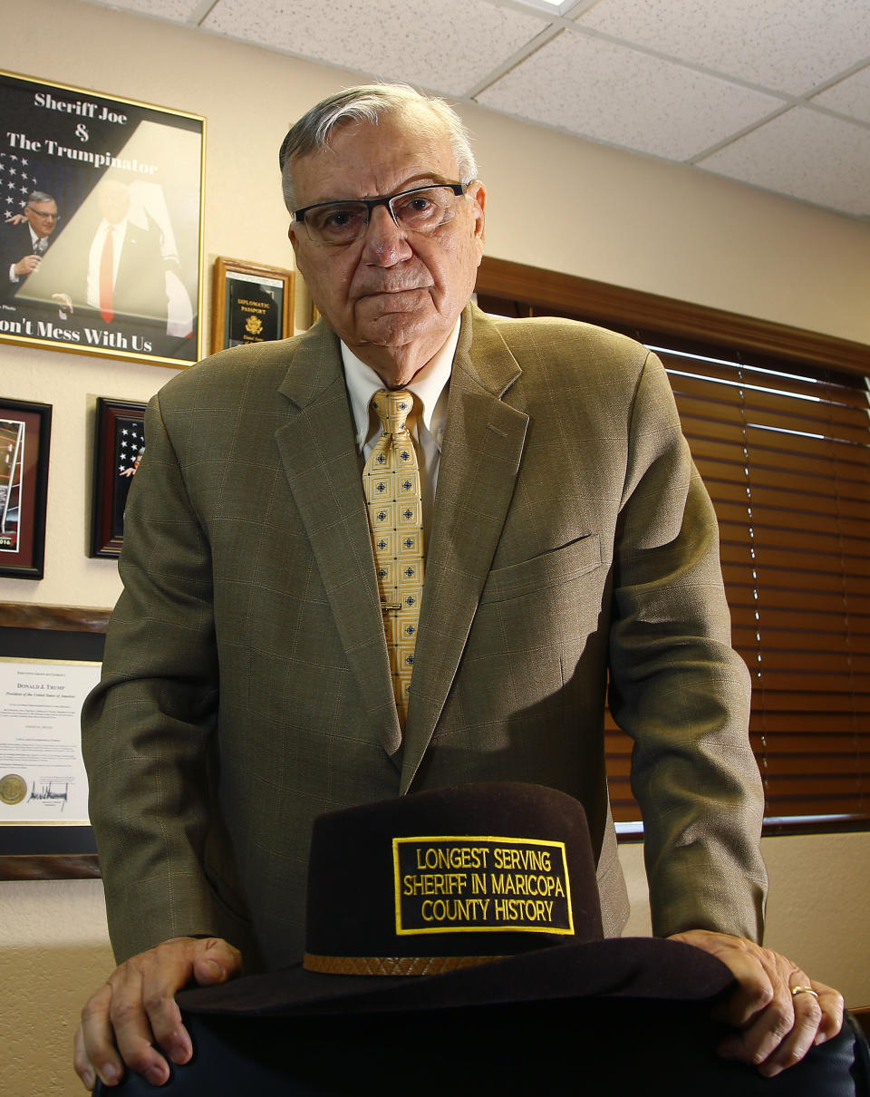 FILE- In this Aug. 26, 2019 file photo former Arizona Maricopa County Sheriff Joe Arpaio poses for a picture in his office in Fountain Hills, Ariz. Arpaio is aiming to get back his previous job as metro Phoenix’s sheriff even though he could easily walk away from politics and enjoy retirement. The former six-term sheriff denies he's running to stroke his ego, quench a thirst for publicity or lessen any boredom he might be experiencing. Instead, the 87-year-old says he wants to do whatever he can to help President Donald Trump and vows to bring back his immigration crackdowns and complex of jail tents. (AP Photo/Ross D. Franklin, File)