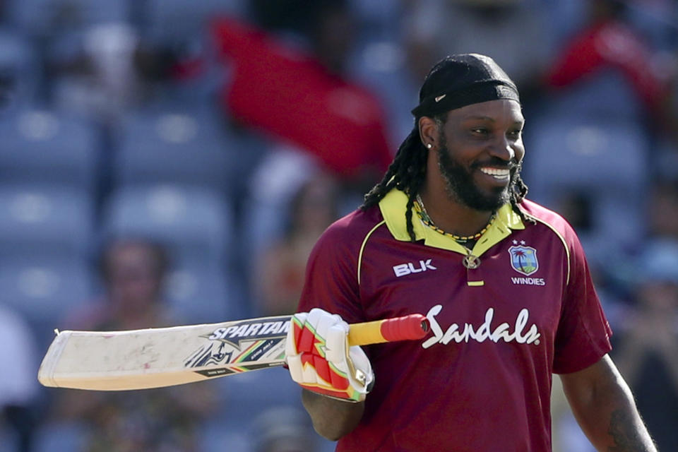 FILE - In this Wednesday, Feb. 27, 2019 file photo, West Indies' Chris Gayle celebrates after scoring a century against West Indies during the fourth One Day International cricket match at the National Stadium in St. George's, Grenada. At 39 and approaching 300 ODIs, the powerful West Indies opener is playing his final World Cup and the last 50-over internationals of his career. (AP Photo/Ricardo Mazalan, File)