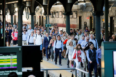 People arrive to the Hoboken Terminal in New Jersey to commute to New York City, U.S., July 10, 2017. REUTERS/Eduardo Munoz