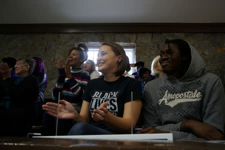 A woman wearing a "Black Lives Matter" shirt cheers during Democratic gubernatorial candidate for Georgia, Stacey Abrams' speech in Newnan, Georgia, U.S., October 25, 2018, ahead of the midterm elections. REUTERS/Lawrence Bryant