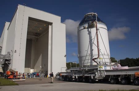 The Orion capsule sits on top of the service module as it is moved from the Operations & Checkout Building to the Payload Hazardous Servicing Facility (L) at Kennedy Space Center, Florida September 11, 2014. REUTERS/Mike Brown