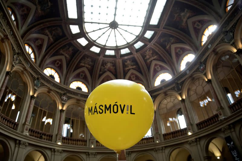 FILE PHOTO: A balloon with the logo of Masmovil is seen during its bourse debut in 2017 in Madrid, Spain