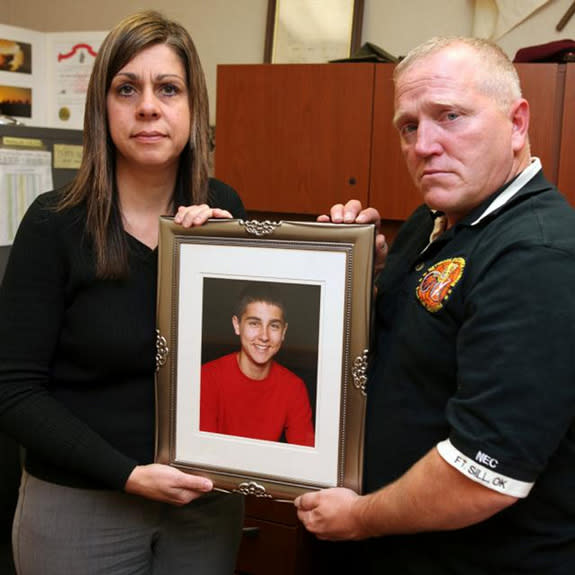 Michelle and David Rauls hold a photograph of their son Nicholas, 13, on Dec. 1 at Knox Hall. Nick committed suicide Feb. 7, 2010, at the family's Elgin home.