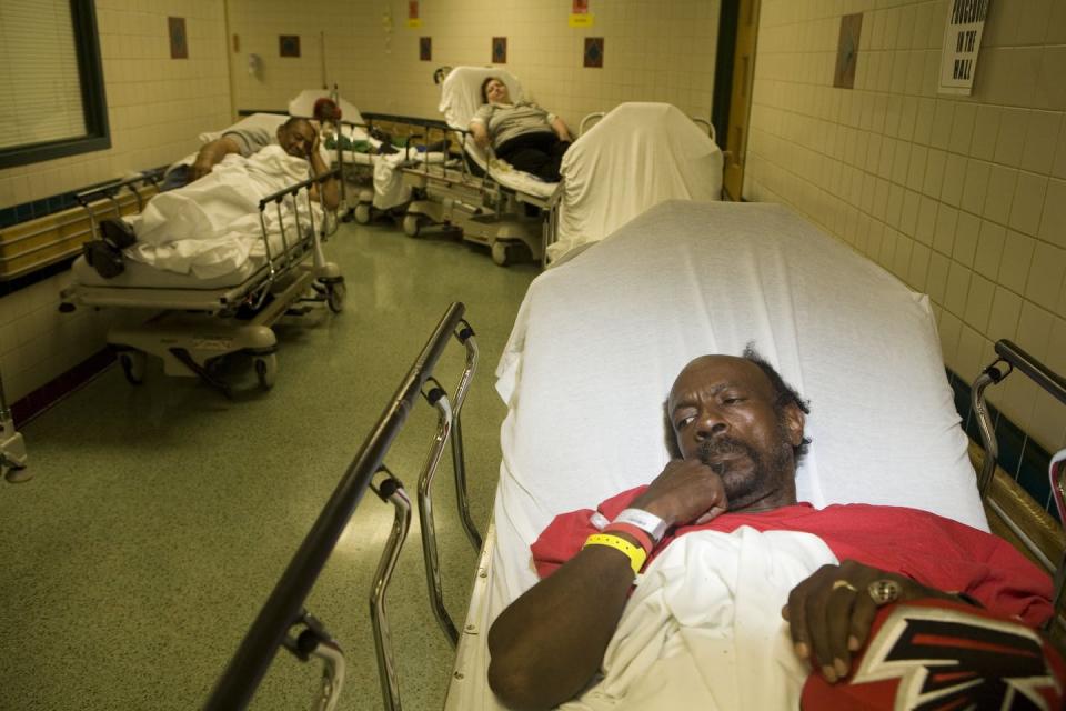 <span class="caption">Patients forced to wait for treatment in the hallways of an Atlanta Hospital in 2006 due to lack of space and overcrowding.</span> <span class="attribution"><a class="link " href="https://www.gettyimages.com/detail/news-photo/at-grady-memorial-hospital-emergency-department-where-many-news-photo/98618601?adppopup=true" rel="nofollow noopener" target="_blank" data-ylk="slk:Jonathan Torgovnik/Getty Images);elm:context_link;itc:0;sec:content-canvas">Jonathan Torgovnik/Getty Images)</a></span>