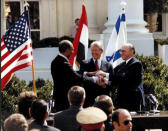 FILE PHOTO: U.S. President Jimmy Carter, Egyptian President Anwar Sadat and Israeli Prime Minister Menachem Begin join hands in celebration