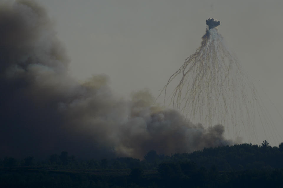 A shell from Israeli artillery explodes over the border line at the Alma al-Shaab border village with Israel, south Lebanon, Friday, Oct. 13, 2023. An Israeli shell landed in a gathering of international journalists covering clashes on the border in south Lebanon, killing one and leaving six others injured. (AP Photo/Hassan Ammar)