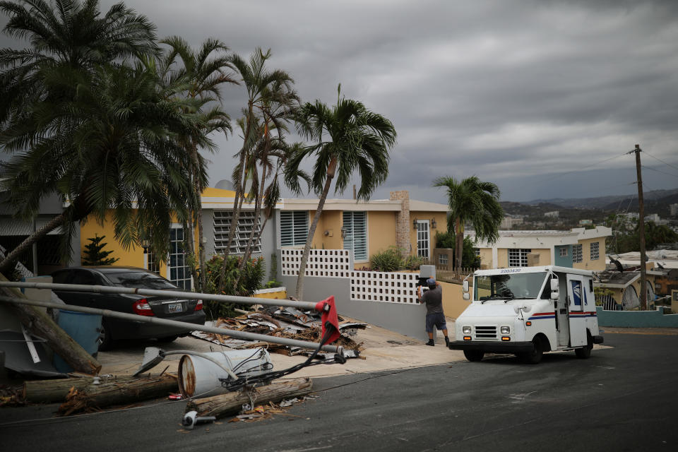 <p>Alfredo Martinez, a mail man for the U.S. Postal Service delivers the mail at an area damaged by Hurricane Maria in San Juan, Puerto Rico, Oct. 6, 2017. (Photo: Carlos Barria/Reuters) </p>