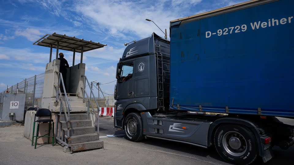A truck carrying humanitarian aid for the Gaza Strip passes through the Kerem Shalom Crossing in southern Israel last March. - Ohad Zwigenberg/AP