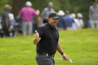 Phil Mickelson reacts to the crowd on the eighth hole during the first round of the U.S. Open golf tournament at The Country Club, Thursday, June 16, 2022, in Brookline, Mass. (AP Photo/Charlie Riedel)