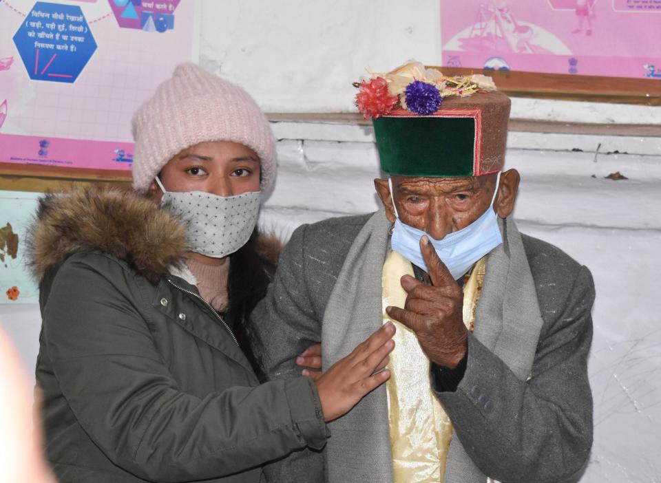 Shyam Saran Negi, believed to be India’s oldest voter at 103 years of age, shows his inked finger after casting vote for Panchayat elections, at Kalpa in Kinnaur, on Sunday, 17 January 2021.