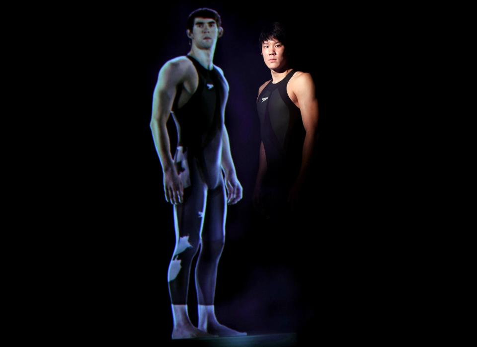 Korean swimmer Park Tae-Hwan poses with Michael Phelps hologram appearance during the Speedo Swimsuit Launch press conference at the National Museum of Emerging Science and Innovation on Feb. 12, 2008, in Tokyo.