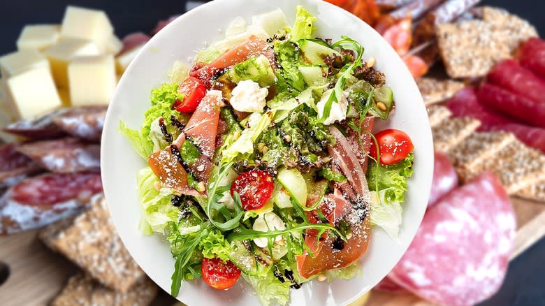 a salad in front of a deli counter