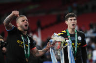 Manchester City's Kyle Walker, left, holds the trophy with his teammate Manchester City's John Stones after winning the English League Cup Final soccer match between Aston Villa and Manchester City, at Wembley stadium, in London, England, Sunday, March 1, 2020. (AP Photo/Alastair Grant)