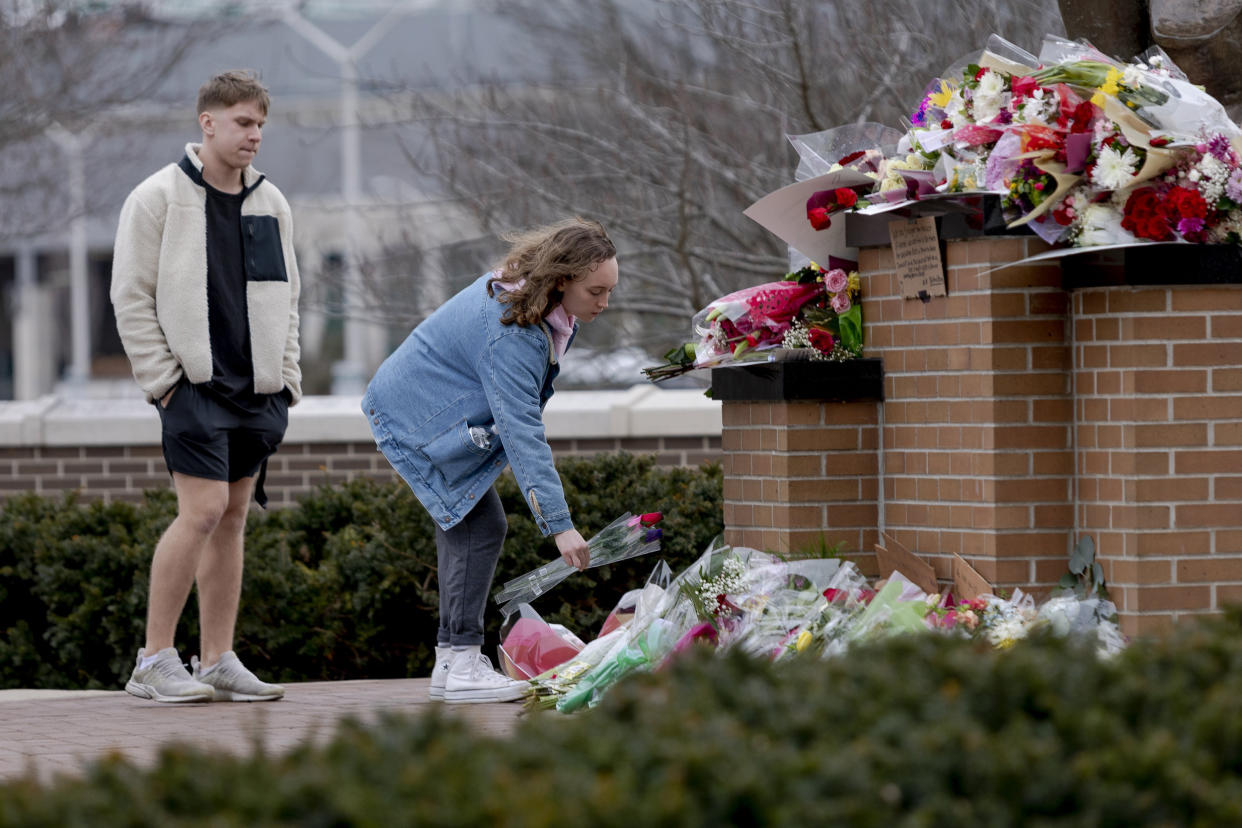 People place flowers at the Spartan Statue at Michigan State University in Lansing, Mich. (Sylvia Jarrus for NBC News)