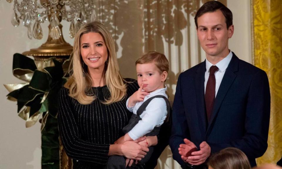 Ivanka Trump holds her son Theodore alongside her husband Jared Kushner in the East Room of the White House.