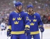 Sep 25, 2016; Toronto, Ontario, Canada; Team Sweden forward Daniel Sedin (22) and defenceman Erik Karlsson (65) discuss a play during a break in the action against Team Europe during the first period of a semifinal game in the 2016 World Cup of Hockey at Air Canada Centre. Mandatory Credit: John E. Sokolowski-USA TODAY Sports