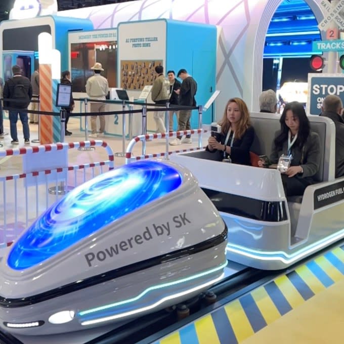 Passengers sit in a theme park-like hydrogen train ride at CES 2024 in Las Vegas.