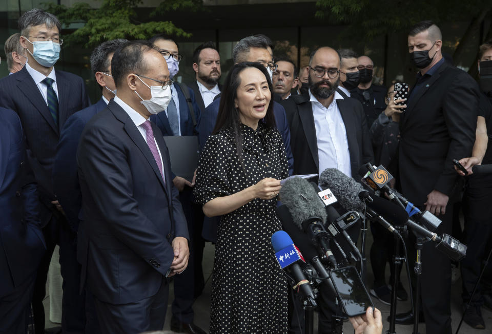 Meng Wanzhou, chief financial officer of Huawei, reads a statement outside B.C. Supreme Court in Vancouver, British Columbia, Friday, Sept. 24, 2021. (Darryl Dyck/The Canadian Press via AP)