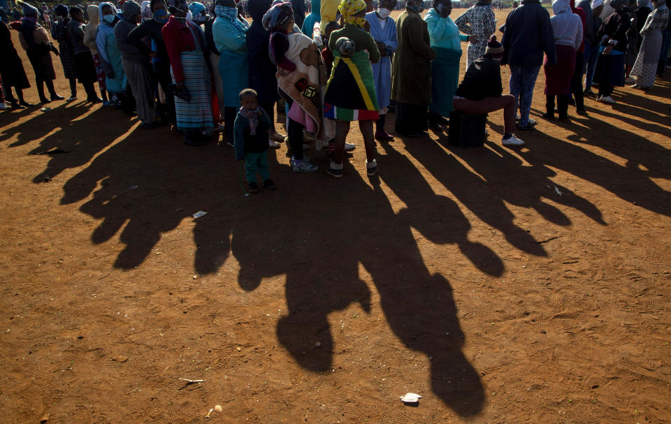 FILE — In this May 20, 2020 file photo, people affected by the coronavirus economic downturn line up to receive food parcels in Pretoria, South Africa, South Africa's economy is expected to decline by 7.2% this year, its worst performance in 90 years, as the coronavirus pandemic takes a toll on sub-Saharan Africa's most developed country. (AP Photo/Themba Hadebe/File)