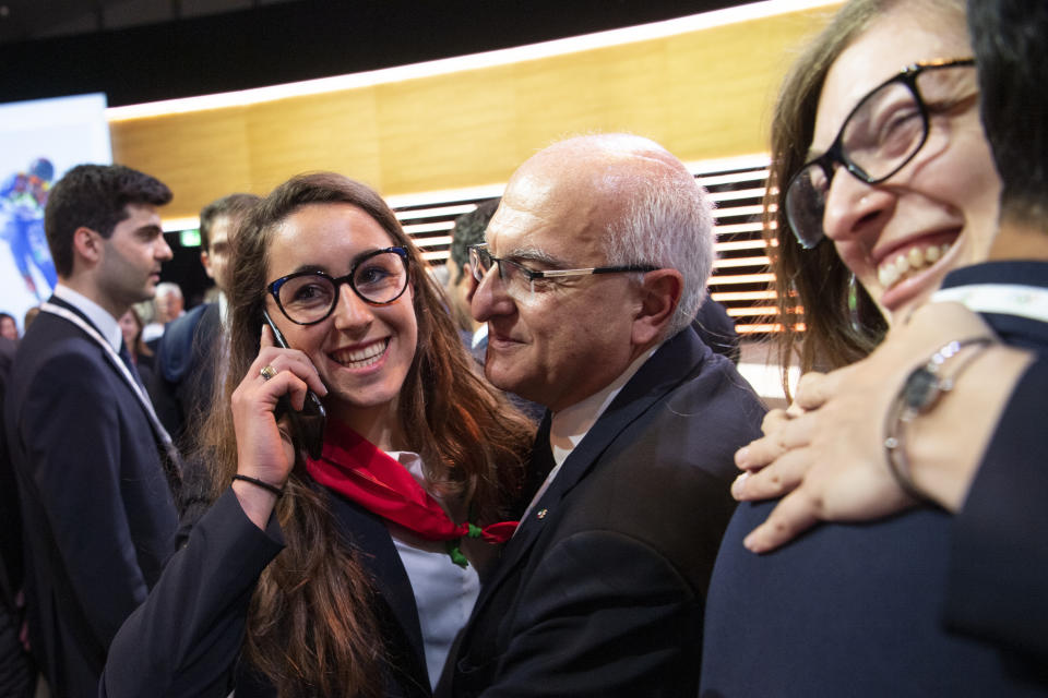 Italian skier Sofia Goggia celebrates with members of the Italian delegation after International Olympic Committee (IOC) president Thomas Bach from Germany announced that Milan-Cortina has won the bid to host the 2026 Winter Olympic Games, during the first day of the 134th Session of the International Olympic Committee (IOC), at the SwissTech Convention Centre, in Lausanne, Switzerland, Monday, June 24, 2019. Italy will host the 2026 Olympics in Milan and Cortina d'Ampezzo, taking the Winter Games to the Alpine country for the second time in 20 years. (Jean-Christophe Bott/Keystone via AP)