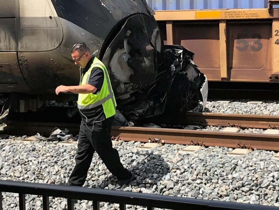 FILE - In this Sept. 13, 2019 photo, police investigate the scene of a collision between a Brightline train and a car in Oakland Park, Fla. Florida higher-speed passenger train service tied to Richard Branson’s Virgin Group has the worst per-mile death rate in the U.S. The first death involving a Brightline train happened in July 2017 during test runs. An Associated Press analysis of Federal Railroad Administration data shows that since then, 40 more have been killed. That amounts to a rate of more than one a month and about one for every 29,000 miles (47,000 kilometers) the trains have traveled since the first death. (Wayne Roustan/South Florida Sun-Sentinel via AP)