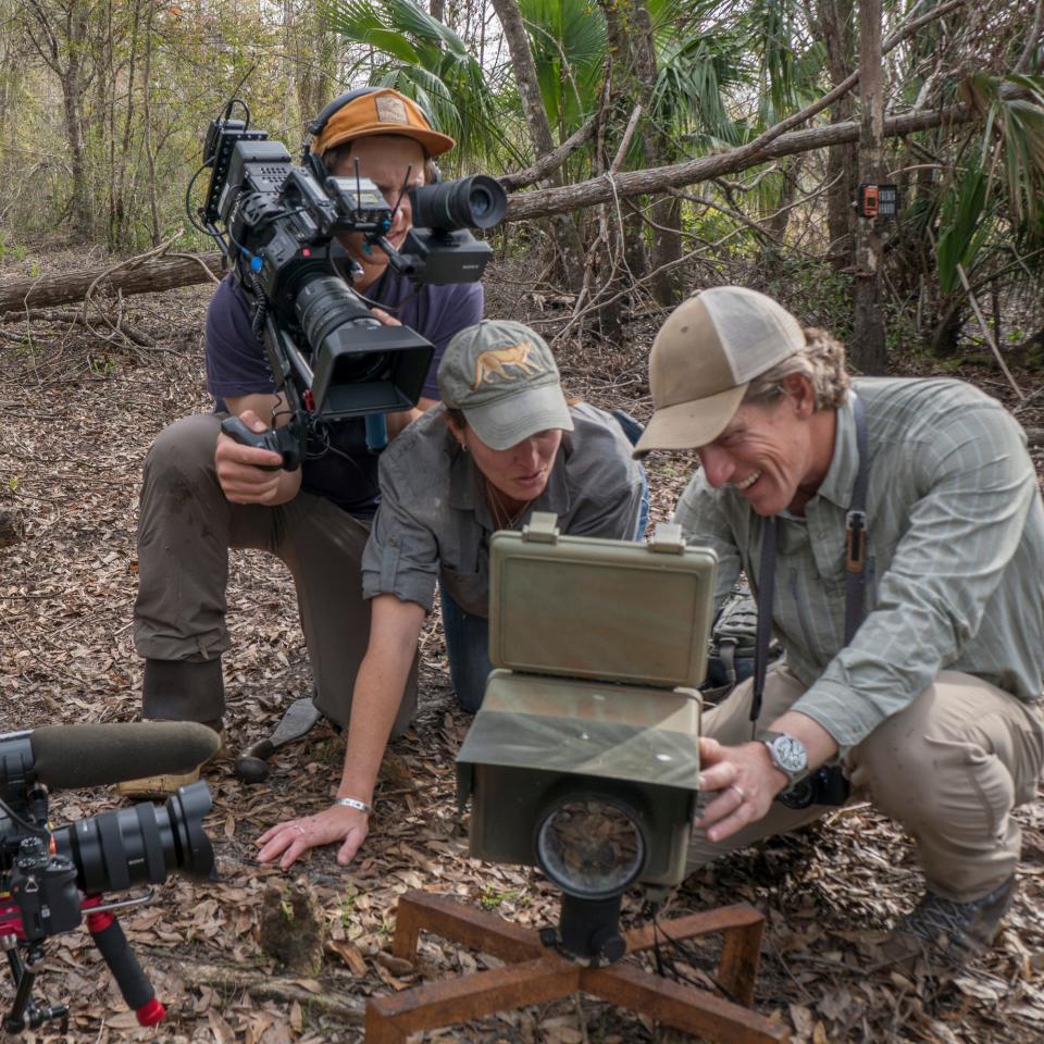 Carlton Ward Jr., right, and Jen Korn examine the first photos of Florida panther kittens seen north of the Caloosahatchee River in nearly 50 years as cinematographers Danny Schmidt and Eric Bendick capture the moment. The team spent about six years compiling footage for the documentary "Path of the Panther."