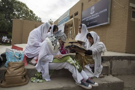 Psychology students study outside the Competence and Trauma Centre for Journalists inside a university's psychology department in Peshawar November 24, 2014. REUTERS/Zohra Bensemra