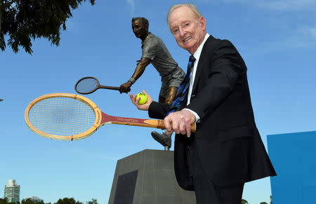 Australian tennis legend Rod Laver poses in front of a life-size statue of himself outside the Rod Laver Arena in Melbourne, Australia, January 5, 2017. AAP/Julian Smith/via REUTERS