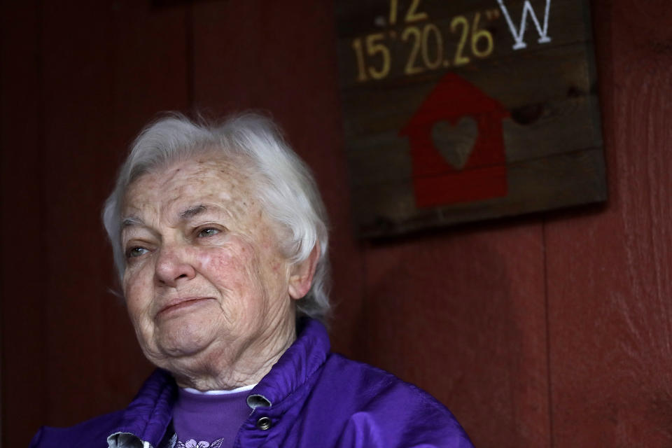 Alice Lowell, of Hardwick, Mass., who lost her husband to the coronavirus, speaks to a reporter from The Associated Press on the front porch of her daughter's home, Thursday, April 30, 2020, in Ware, Mass. Her husband, Air Force veteran Charles Lowell, was a resident at the state-run Holyoke Soldiers' Home. While the death toll at the state-run Holyoke Soldiers' Home continues to climb, federal officials are investigating whether residents were denied proper medical care and the state's top prosecutor is deciding whether to bring legal action. (AP Photo/Steven Senne)