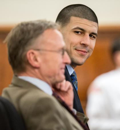 Aaron Hernandez, right, smiles at his attorney Charles Rankin. (AP)