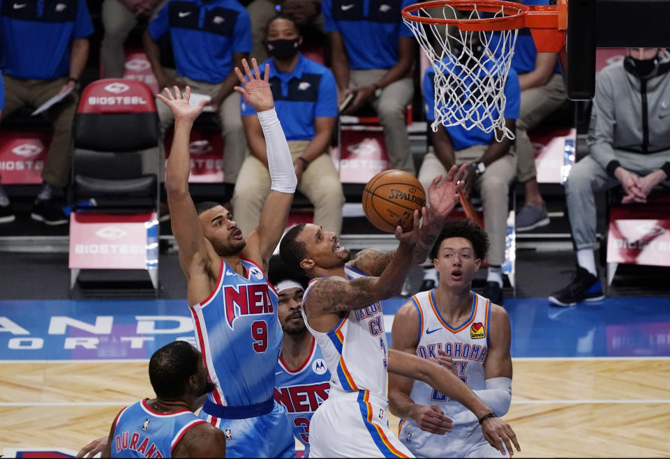 Brooklyn Nets guard Timothe Luwawu-Cabarrot (9) and center Jarrett Allen defend against Oklahoma City Thunder guard George Hill (3) as Hill goes up for a layup during the first quarter of an NBA basketball game Sunday, Jan. 10, 2021, in New York. (AP Photo/Kathy Willens)