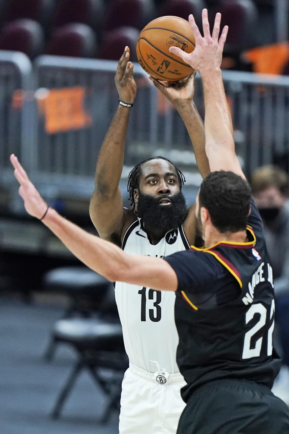 Brooklyn Nets' James Harden (13) shoots over Cleveland Cavaliers' Larry Nance Jr. (22) during the second half of an NBA basketball game, Wednesday, Jan. 20, 2021, in Cleveland. The Cavaliers won 147-135 in double-overtime. (AP Photo/Tony Dejak)