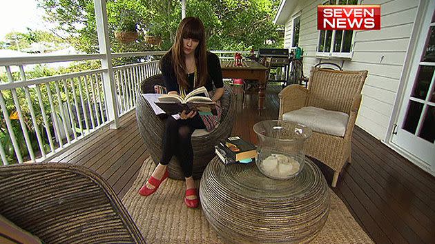 Australia's most successful international novelist reading at her Brisbane home.