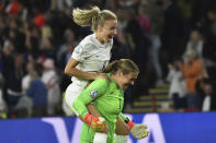 England's Leah Williamson, left, and goalkeeper Mary Earps selebrate after England's Alessia Russo scored their side's third goal during the Women Euro 2022 semi final soccer match between England and Sweden at the Bramall Lane Stadium in Sheffield, England, Tuesday, July 26, 2022. (AP Photo/Rui Vieira)