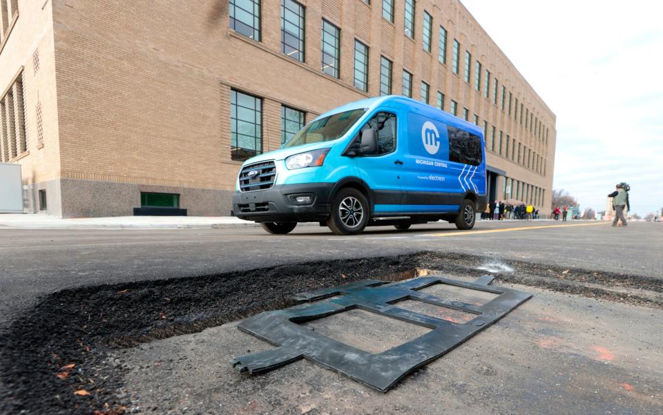 An electric van doing demonstration runs and being charged by buried rubber panels like this one as it drives up and down 14th Street in Detroit in front of the Newlab at Michigan Central Building on Wednesday, November 29, 2023. A press conference was held at the building with members of the Michigan Department of Transportation, the Michigan Central building, Electreon and the Michigan Office of Future Mobility and Electrification to announce and talk about this stretch of road that is the first inductive-charging roadway anywhere in the country.