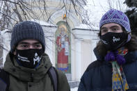 FILE - Supporters of the Memorial human rights group wearing face masks with the words "The Memorial cannot be banned!" gather in front of the Moscow Court in Moscow, Russia, Wednesday, Dec. 29, 2021. On Friday, Oct. 7, 2022 the Nobel Peace Prize was awarded to jailed Belarus rights activist Ales Bialiatski, the Russian group Memorial and the Ukrainian organization Center for Civil Liberties. (AP Photo/Alexander Zemlianichenko, File)