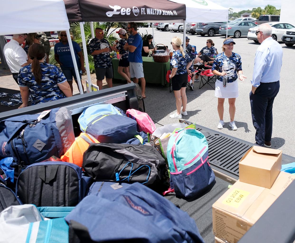 Donated backpacks stuffed with school supplies fill the bed of a truck Friday during the Emerald Coast Association of Realtors' "Cram the Van/Stuff the Truck" donation drive at AJ's on the Bayou.