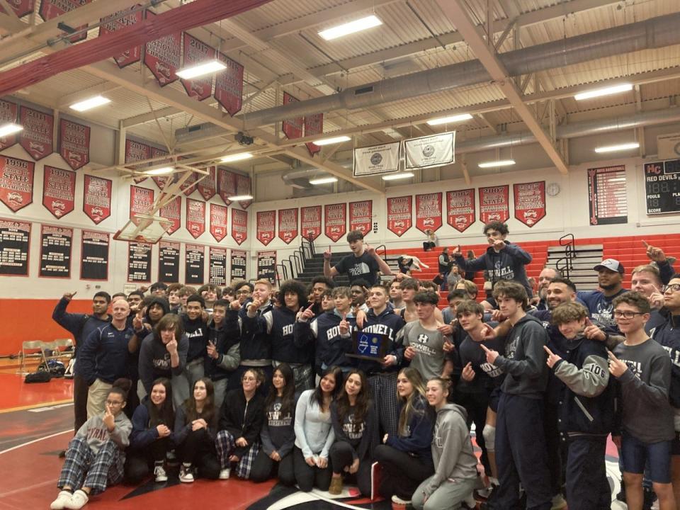 The Howell wrestling team poses after winning the Central Group 5 title on Feb. 8, 2023