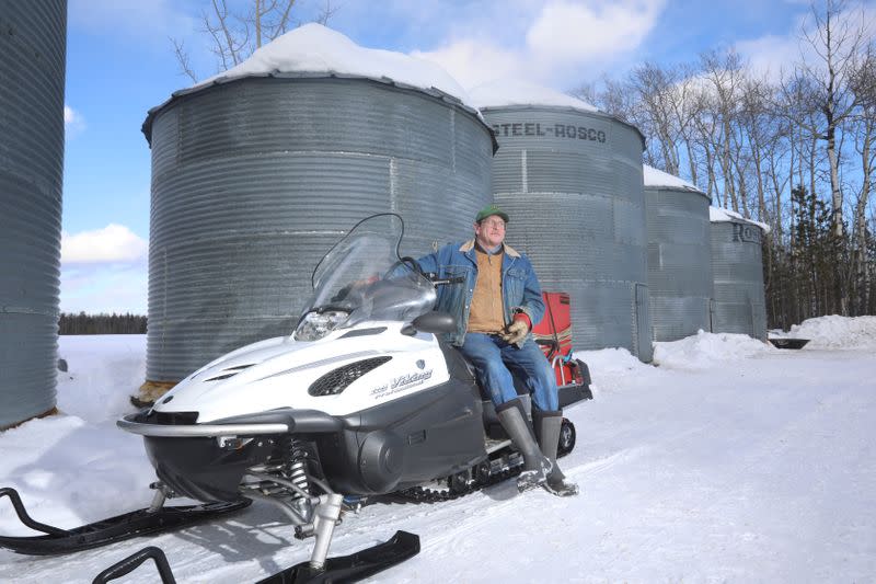Farmer Steve Mackenzie-Grieve sits for a portrait on the snowmobile he uses to drive to his grain bins at the Yukon Grain Farm near Whitehorse