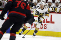 Vegas Golden Knights' Jonathan Marchessault (81) moves the puck against Carolina Hurricanes' Brady Skjei (76) during the first period of an NHL hockey game in Raleigh, N.C., Saturday, March 11, 2023. (AP Photo/Karl B DeBlaker)