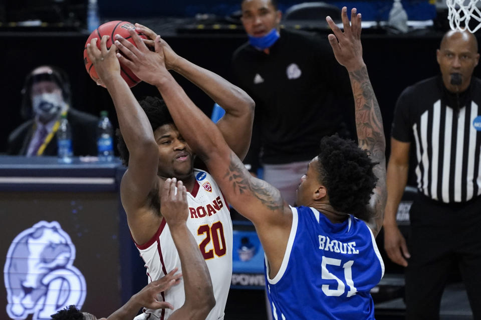 Drake forward Darnell Brodie (51) blocks USC guard Ethan Anderson (20) during the first half of a men's college basketball game in the first round of the NCAA tournament at Bankers Life Fieldhouse in Indianapolis, Saturday, March 20, 2021. (AP Photo/Paul Sancya)