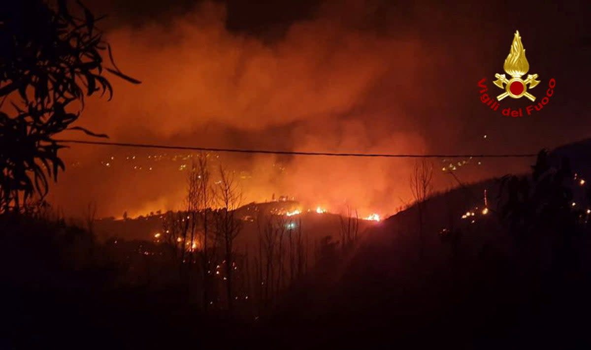 Flames and smoke rise as a wildfire burns near the Sicilian village of Curcuraci near Messina, Italy (via REUTERS)