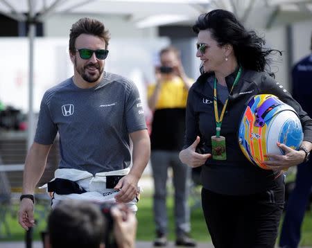 Formula One - F1 - Australian Grand Prix - Melbourne, Australia - 23/03/2017 McLaren driver Fernando Alonso of Spain (L) walks to the driver portrait session at the first race of the year. REUTERS/Jason Reed