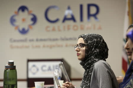 University of California Riverside student Amal Ali, 22, watches the Republican presidential debate at the Council on American-Islamic Relations (CAIR) office in Anaheim, California December 15, 2015. REUTERS/Jason Redmond