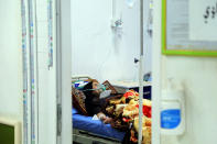 A coronavirus patient receives treatment at a hospital in Najaf, Iraq, Wednesday, July 14, 2021. Infections in Iraq have surged to record highs amid a third wave spurred by the more aggressive delta variant, and long-neglected hospitals suffering the effects of decades of war are overwhelmed with severely ill patients. (AP Photo/Anmar Khalil)