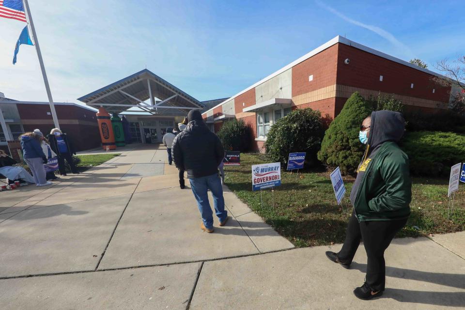 A member of the public waits in a long line in the cold to cast their vote on Election Day on Tuesday, Nov. 3, 2020, at Thurgood Marshall Elementary School in Bear.