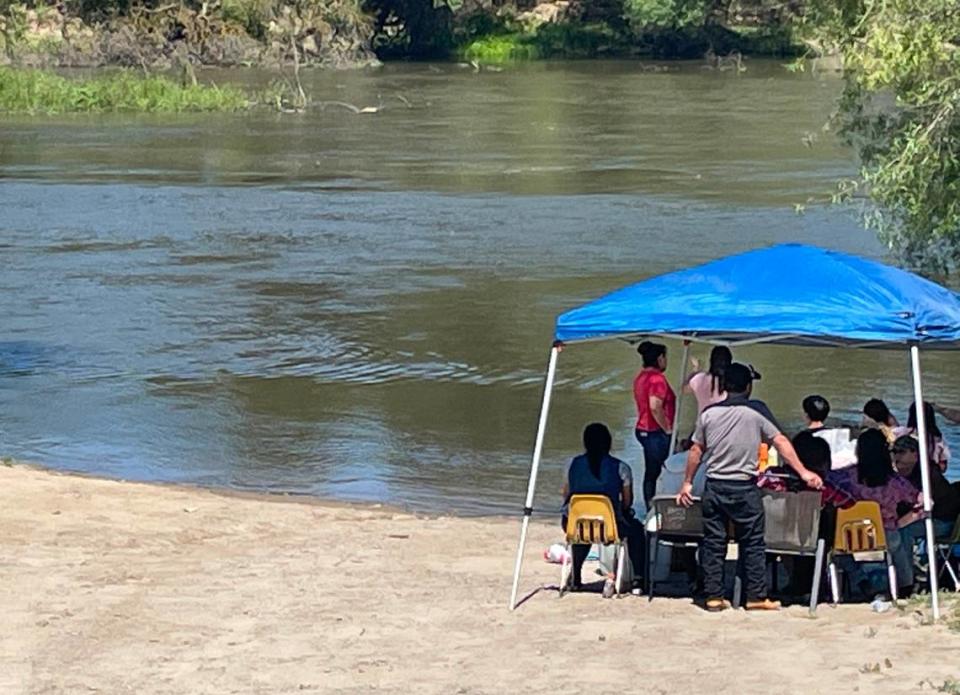 Family of Brenda Duran waited along the San Joaquin River as divers searched for Duran who remained missing after jumping into the water Thursday to aid her struggling daughter.