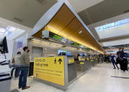 Employees wait for testing supplies as Los Angeles International Airport is offering walk-up coronavirus testing for $150 in the Tom Bradley International Terminal, in Los Angeles, Tuesday, Nov. 17, 2020. (Keith Birmingham/The Orange County Register via AP)