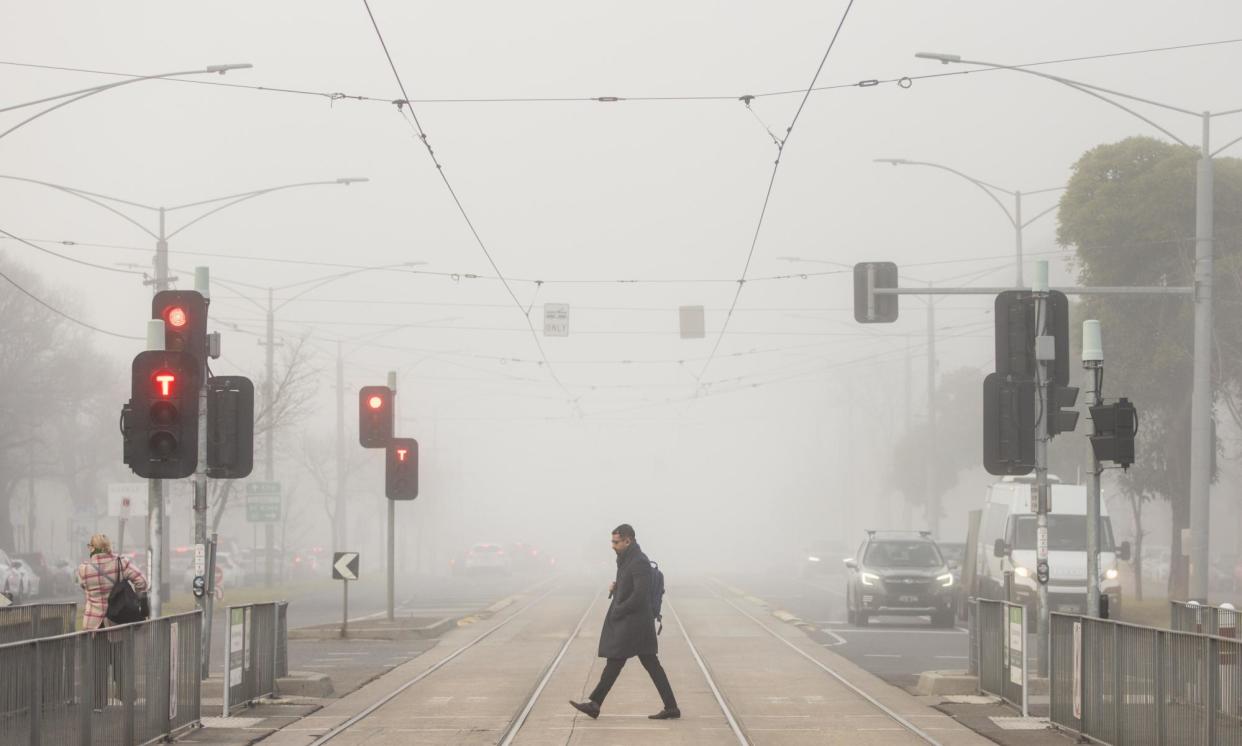 <span>Fog shrouds Flemington Road in Melbourne on Thursday morning. Cold weather is forecast for coming days, the BoM says.</span><span>Photograph: Diego Fedele/EPA</span>