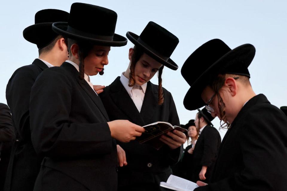 Ultra-Orthodox boys prepare for Yom Kippur, the most important day in the Jewish calendar, in the Israeli city of Netanya. <a href="https://www.gettyimages.com/detail/news-photo/ultra-orthodox-jewish-men-and-children-perform-the-tashlich-news-photo/1243700909?adppopup=true" rel="nofollow noopener" target="_blank" data-ylk="slk:Jack Guez/AFP via Getty Images;elm:context_link;itc:0;sec:content-canvas" class="link ">Jack Guez/AFP via Getty Images</a>